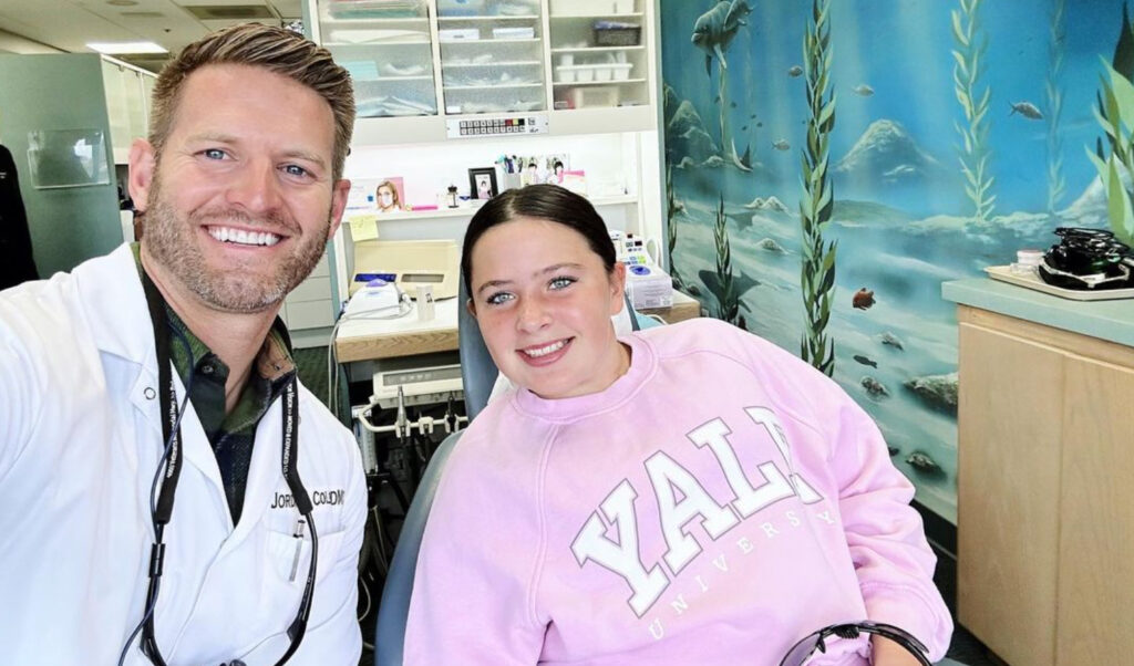 Dr Jordan Colby, orthodontist in Fallbrook CA, with a smiling patient